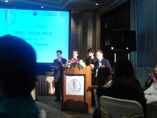Michael and James on stage with projecter screen showing "Gala dinner WBU-ICEB 2012"