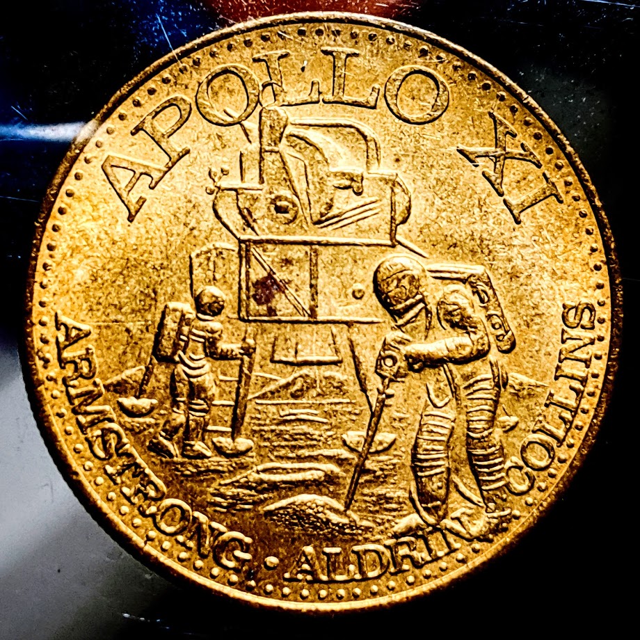 Apollo XI medal (Image of lunar lander with two astronauts.  Text reads "APOLLO XI ARMSTRONG ALDRIN COLLINS")