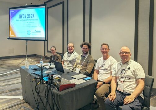 Mick, James, Sean, Gerald and Quentin seated in front of the room with our opening slide on the screen ready to present our session at CSUN 2024