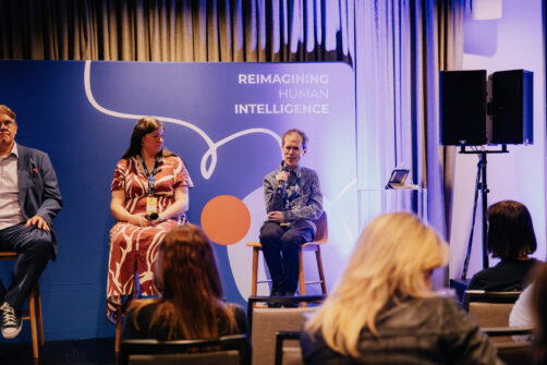 Photo from the panel discussion at Something Digital Conference 2025: From Voice Interfaces to Micro-Interactions: The Innovations Powering Digital Accessibility. Pictured is Allison Ravenhall [Commonwealth Bank] watching Michael Curran [NV Access] speak.  Photo courtesy Nadine Zrinzo [Something Digital]