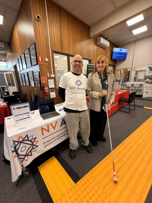 Quentin (NV Access) and Elise )Data Australasia) in front of the NV Access table at SVRC. Elise is trying a new Sensaball cane tip. Photo courtesy Elise Lonsdale